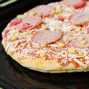 Frozen pizza with salami, cheese, corn and pepper